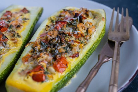 Photo for Zucchini stuffed with shrimps, vegetables and cheese. Baked zucchini boats, close up - Royalty Free Image