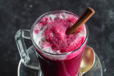 Photo for Beetroot vanilla latte from fresh beetroot juice blended with vanilla and milk in a transparent cup on the table in cafe, close up. Trendy healthy drink - Royalty Free Image