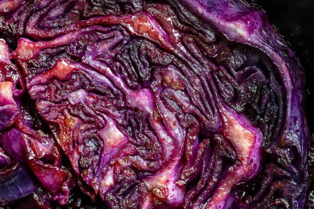 Photo for Red cabbage wedges are pan-fried until lightly charred, then braised in mulled wine. Background of fry blue cabbage in a section, macro. Close up, top view. Texture and pattern of purple cabbage - Royalty Free Image