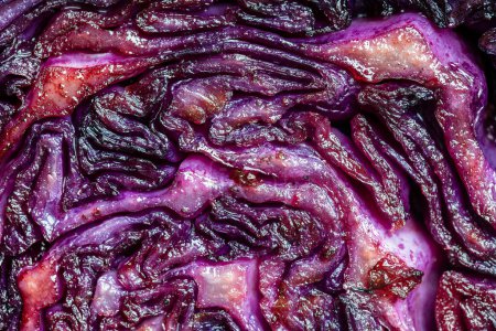 Photo for Red cabbage wedges are pan-fried until lightly charred, then braised in mulled wine. Background of fry blue cabbage in a section, macro. Close up, top view. Texture and pattern of purple cabbage - Royalty Free Image