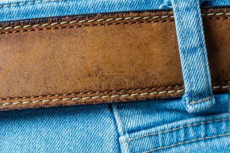 Photo for Leather brown belt in blue denim pants. Close up view - Royalty Free Image