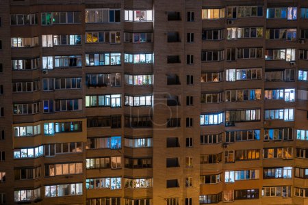 Foto de Facade of an apartment building with luminous windows at night, Kyiv, Ukraine - Imagen libre de derechos