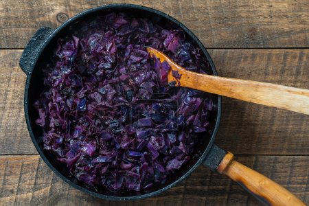 Photo for Red cabbage are pan-fried until lightly charred, then braised in mulled wine. Background of fry blue cabbage in a section, macro. Close up, top view. Texture and pattern of purple cabbage - Royalty Free Image