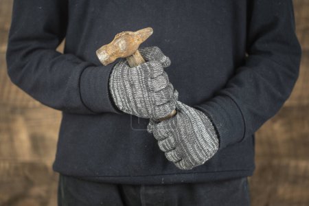 Photo for Man worker hand holding a old hammer, close up, concept for repair work - Royalty Free Image