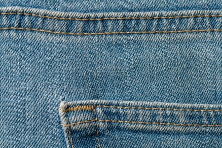 Téléchargez les photos : Tissu jeans bleu avec fond de poche ou texture denim. Vue rapprochée - en image libre de droit