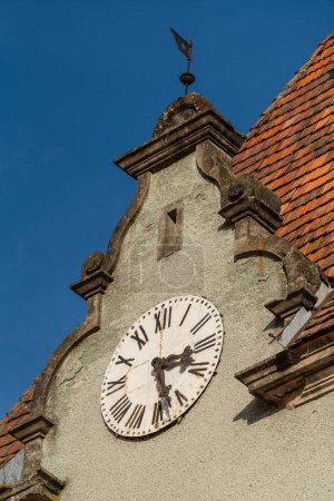 Photo for Detail of a building with a big old clock on the roof on a sunny day on a blue sky background, close up. West Ukraine - Royalty Free Image