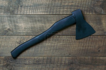 Téléchargez les photos : Black axe on wooden background, top view, close up - en image libre de droit