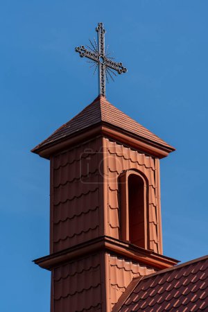 Photo for Metal cross with roof tiles in the blue sky background. West Ukraine - Royalty Free Image