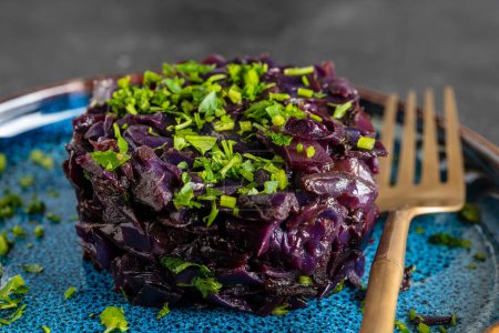 Photo for Fried red cabbage stewed in mulled wine served in plate. Background of fried blue cabbage, macro. Close up - Royalty Free Image