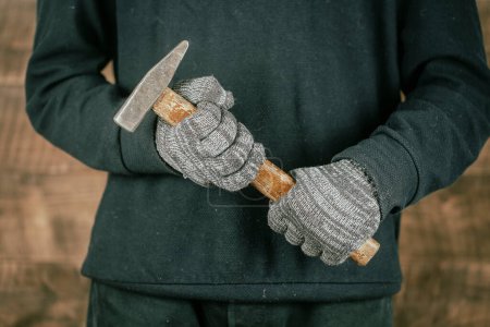 Photo for Man worker hand holding a old hammer, close up, concept for repair work - Royalty Free Image