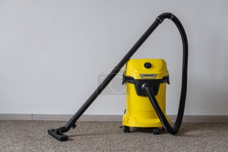 Photo for Kyiv, Ukraine - Jan 23, 2023: Karcher WD 3 V wet and dry vacuum cleaner. Yellow Karcher vacuum cleaner in home, close up - Royalty Free Image