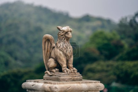 Photo for Gargoyle statue, chimeras, in the form of a medieval winged monster, from the royal castle in Bana hill, tourism site in Da Nang, Vietnam. Gothic old vintage gargoyle in a french village near Danang - Royalty Free Image