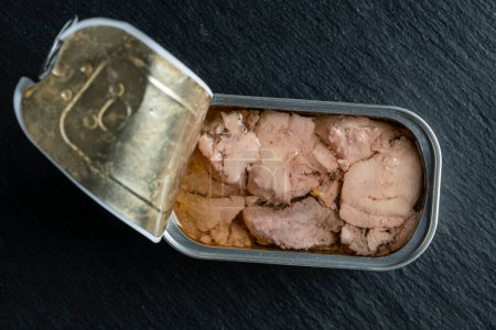 Photo for Open tin can with cod liver on black background, close up, top view - Royalty Free Image