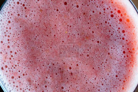 Téléchargez les photos : Healthy eating, food, dieting and vegetarian concept - glass of juice smoothie from strawberries. Pink strawberry shake with banana and honey on the wooden background, close up, top view - en image libre de droit