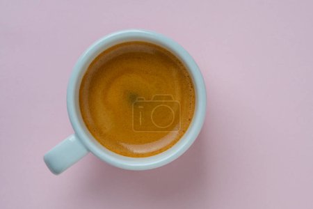 Photo for White porcelain espresso coffee cup over pink background, top view, copy space, close up. Hot coffee in a breakfast - Royalty Free Image