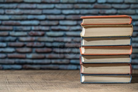 Photo for Closeup book stack in the library room and bookshelf for business and education background, back to school concept - Royalty Free Image