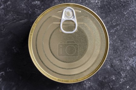 Photo for Closed canned food on a black background, close up, top view - Royalty Free Image