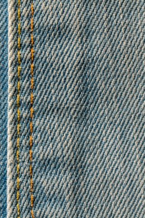 Photo for Blue jeans fabric background or denim texture with seam. Close up view - Royalty Free Image
