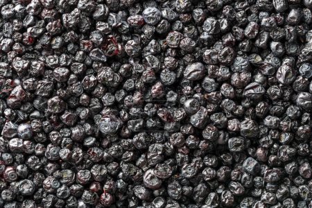 Photo for Dry wild blueberry in the background, close up, top view, macro. A way to preserve vitamins. Vegetarian meal, healthy and useful. Dried bilberry, wild berry - Royalty Free Image