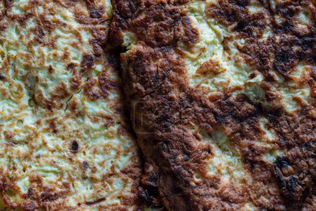 Photo for Fried big thick savory zucchini pancakes, top view of fragment close up - Royalty Free Image