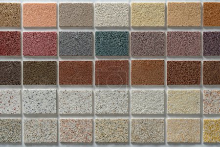 Photo for Samples of multi colored plaster for the decoration of the facade and interior of buildings, color palette. Presentation of building materials on background, close up, top view - Royalty Free Image