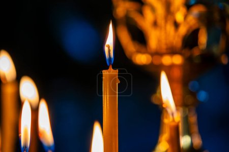 Photo for Burning church wax candles in a candlestick, close up. Concept of religion, faith, rituals, monasteries, temples, churches, rituals - Royalty Free Image