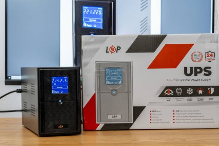 Photo for Kyiv, Ukraine - Aug 11, 2023: Unboxed new UPS LogicPower LPM-UL1550VA on office table. LogicPower is a leading manufacturer of backup power systems and alternative energy sources - Royalty Free Image