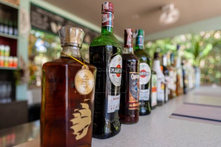 Photo for Koh Phangan, Thailand - february 20, 2022 : Various alcoholic beverages in bottles at a beach bar on the tropical island of Koh Phangan, Thailand - Royalty Free Image