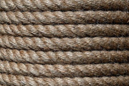 Photo for Natural jute hemp rope rolled into a coil, close up. Brown spool of linen rope texture on the background - Royalty Free Image