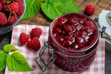 Photo for Red raspberry jam and fresh raspberry on a wooden table. Rustic style, close up - Royalty Free Image