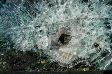 Photo for Bullet hole in armor-piercing glass. Armor piercing glass of damaged military infantry fighting vehicle during war between russia and Ukraine. Background and texture bulletproof glass after an attack - Royalty Free Image