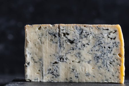 Photo for Piece of blue cheese on dark background, close up - Royalty Free Image
