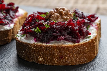 Photo for Toast from a slice of bread with white cream cheese, stewed beetroot pulp, seeds and green dill. Delicious breakfast on morning. Close up - Royalty Free Image