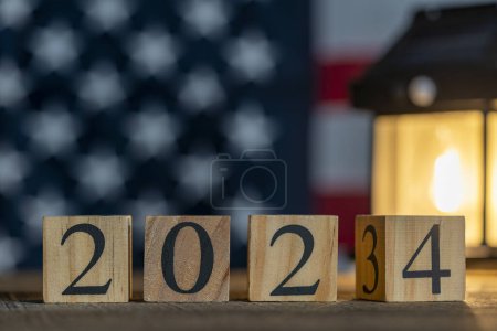 Photo for Starting new year 2024. Flipping of 2023 to 2024 on wooden cube blocks against the backdrop of the American flag. Inspiration to success ideas - Royalty Free Image