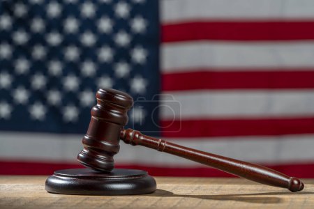 Photo for Wooden judge gavel and soundboard on the American flag background, close up - Royalty Free Image