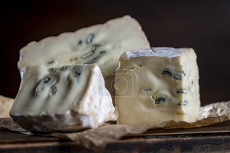 Photo for Slices of blue cheese on an wooden table, close up - Royalty Free Image