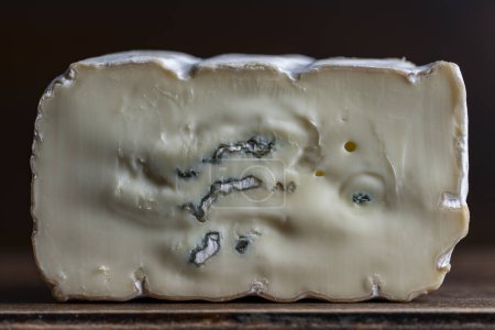 Photo for Slices of blue cheese on an wooden table, close up - Royalty Free Image