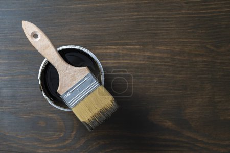 Photo for Top view on paint brush on the opened can on the wooden table background or floor painting and renovation repairing concept, copy space - Royalty Free Image
