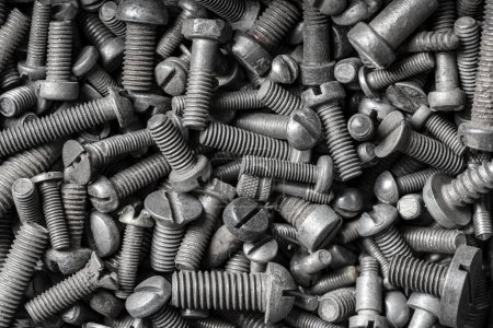 Photo for Many old metal bolts on the background. Chrome screws , close up, top view. Steel bolts pattern. Tools for work - Royalty Free Image