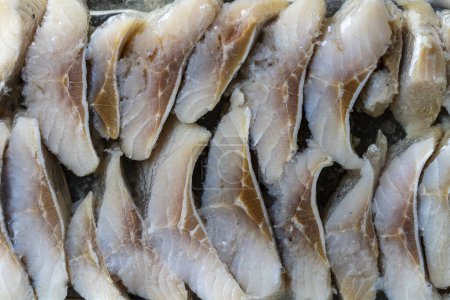 Photo for Sliced herring in oil sauce close up, top view - Royalty Free Image