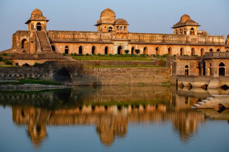 Jahaz Mahal , Ship Palace and blue water lake in sunrise. Mandu, Madhya Pradesh, India. Old Indian architecture on the background
