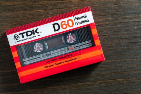 Photo for Kyiv, Ukraine - March 04, 2024 : TDK D 60, old vintage audio cassette on wooden background. Retro analog hi-fi music tape, close up - Royalty Free Image