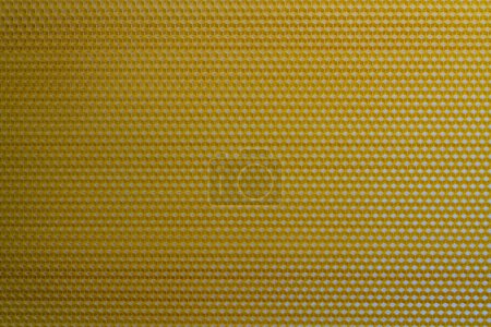 Textura de fondo y patrón de sección voshchina de panal de cera de una colmena de abejas para rellenar con miel. Voshchina una base artificial para la construcción de panales, hoja de cera de las celdas