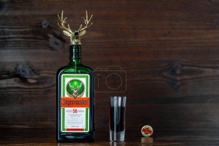 Photo for Kyiv, Ukraine - April 24, 2024 : Jagermeister traditional herb liqueur in glass green bottle with decorative stopper in the shape of a deer's head. German digestif made with 56 herbs and spices - Royalty Free Image