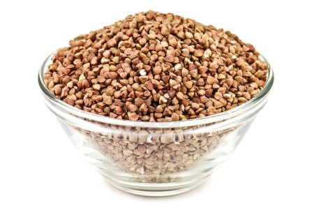Ripe buckwheat in glass bowl on white background