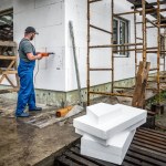 Worker makes building insulation saves energy with styrofoam. Industrial theme