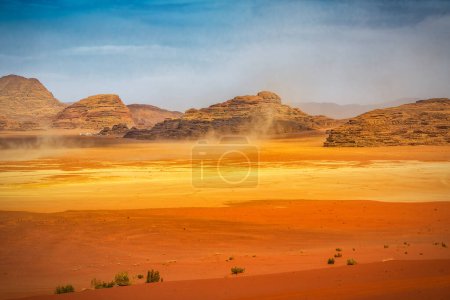 The wind raises the dust in sunny Sahara, Wadi Rum or Arabian desert. Beautiful landscape