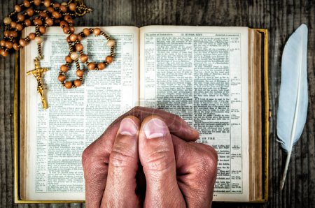 Photo for Hands praying over holy Bible and rosary. Religion theme - Royalty Free Image