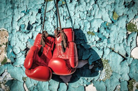 Photo for Red professional boxing gloves on the cracked paint wall - Royalty Free Image