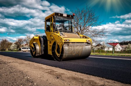 Photo for Road roller rolling new hot asphalt on the new road. Road construction. Industrial theme - Royalty Free Image